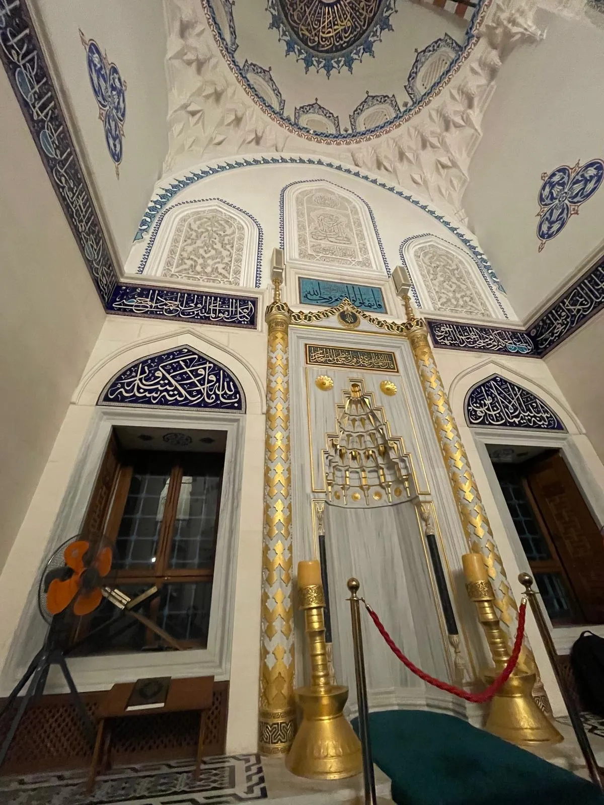 The interior dome of Tokyo Camii mosque, decorated with blue and gold geometric tilework and stained glass.